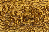 Luang Prabang, Laos - Wat Mai the gilded stucco engravings of the veranda. They narrate the Vessantara Jataka with scenes of everyday life. 